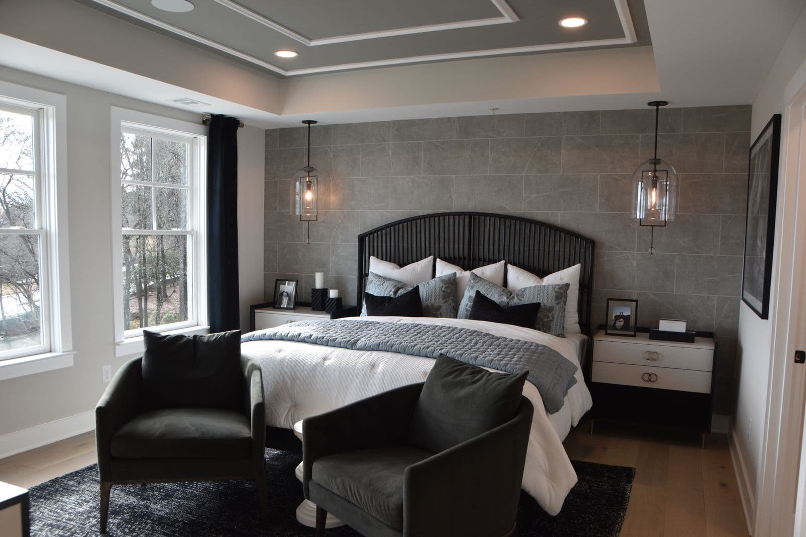 A calm, softly lit bedroom furnished with an upholstered bed